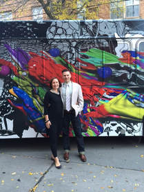 Studio Holland Art donates to arts education. Pictured: Artist Brent Holland and his wife in front of his public art project, Splatter